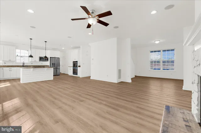 a view of a kitchen with wooden floor and a window