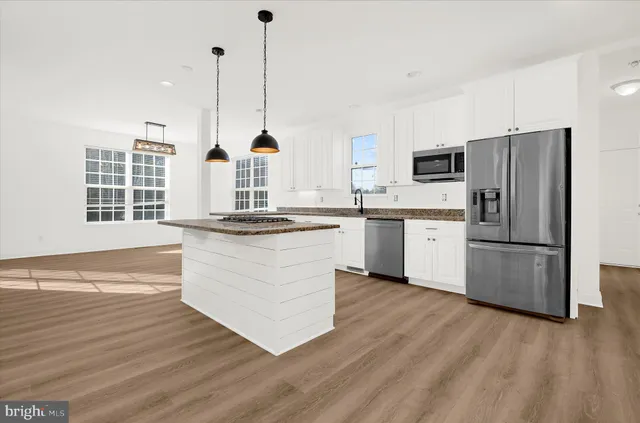 a kitchen with wooden cabinets and stainless steel appliances