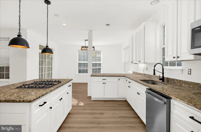 a view of a kitchen with wooden floor and a kitchen