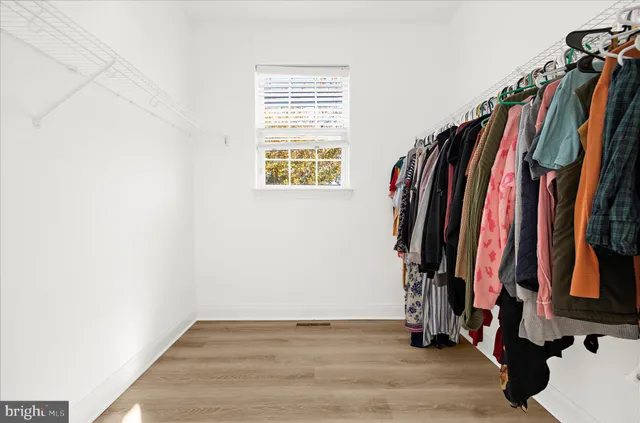 an empty room with a ceiling fan and window