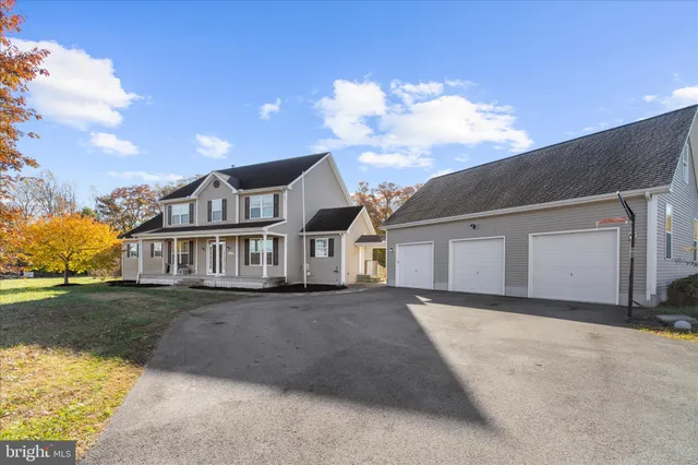 a view of a house with swimming pool next to a yard