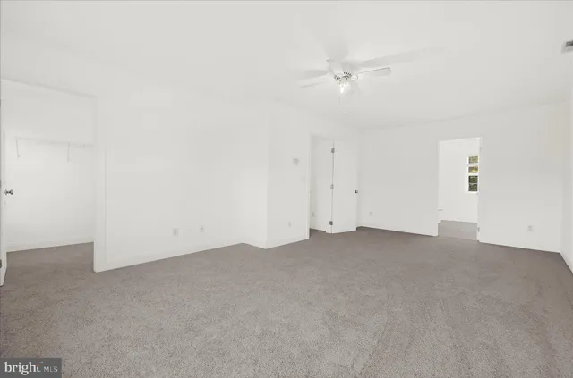 a view of a house with a big yard and large trees