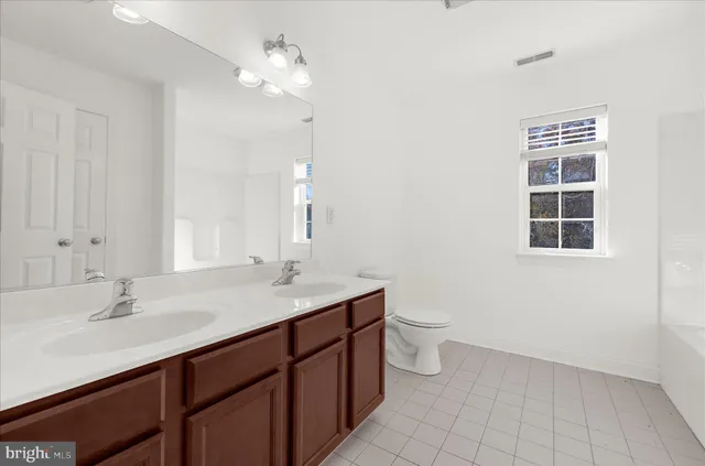 a view of a house with a big yard and large trees