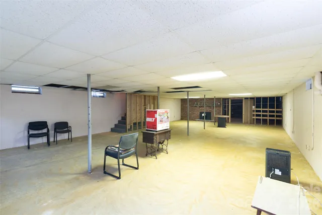 a living room with furniture and kitchen view