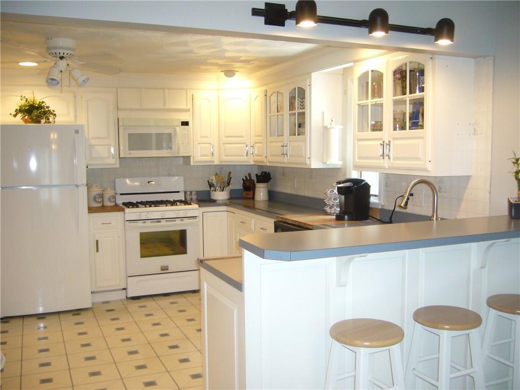 1206 Midland Beaver Road Industry, PA 15052 - Photo 4 of 19 White and bright, SPACIOUS kitchen with breakfast bar and also room for a table.