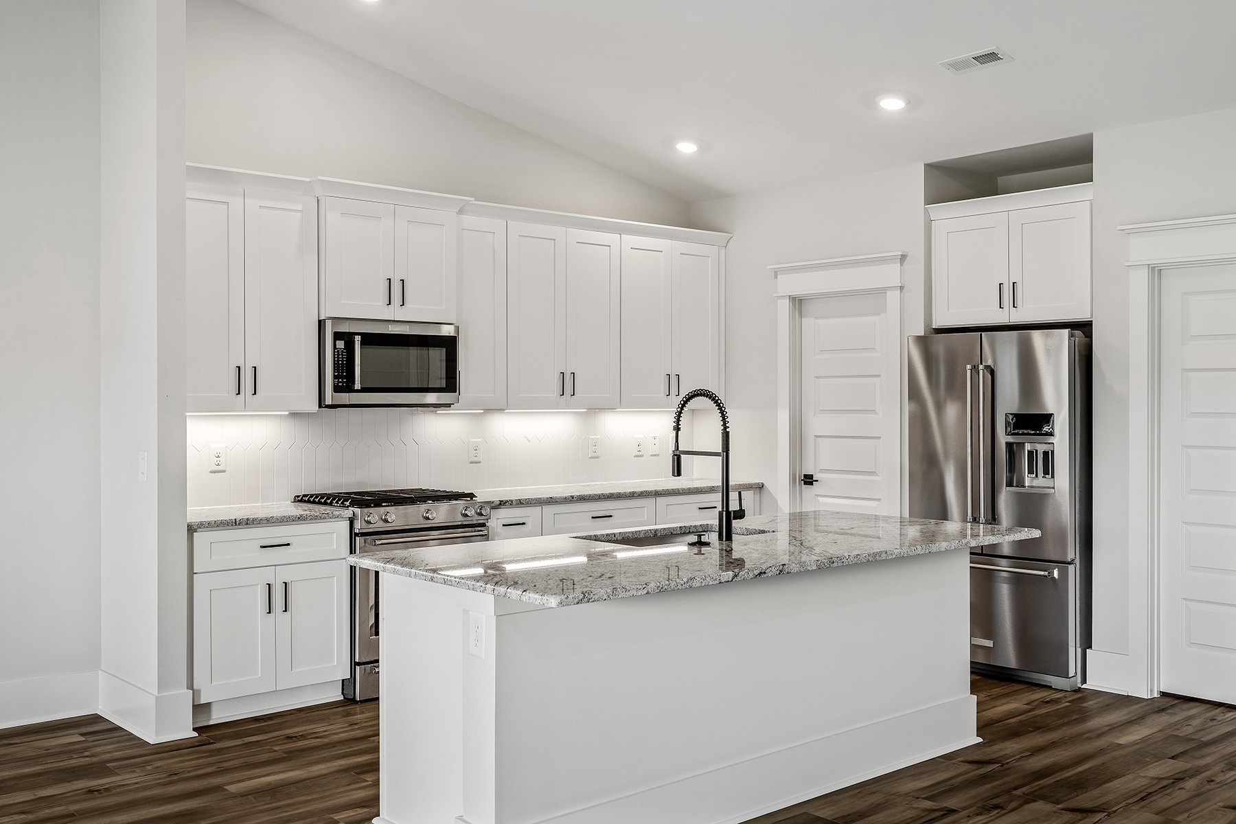 737 Brownlow Road White House, TN 37188 - Photo 5 of 16 a kitchen with kitchen island a counter top space cabinets and stainless steel appliances