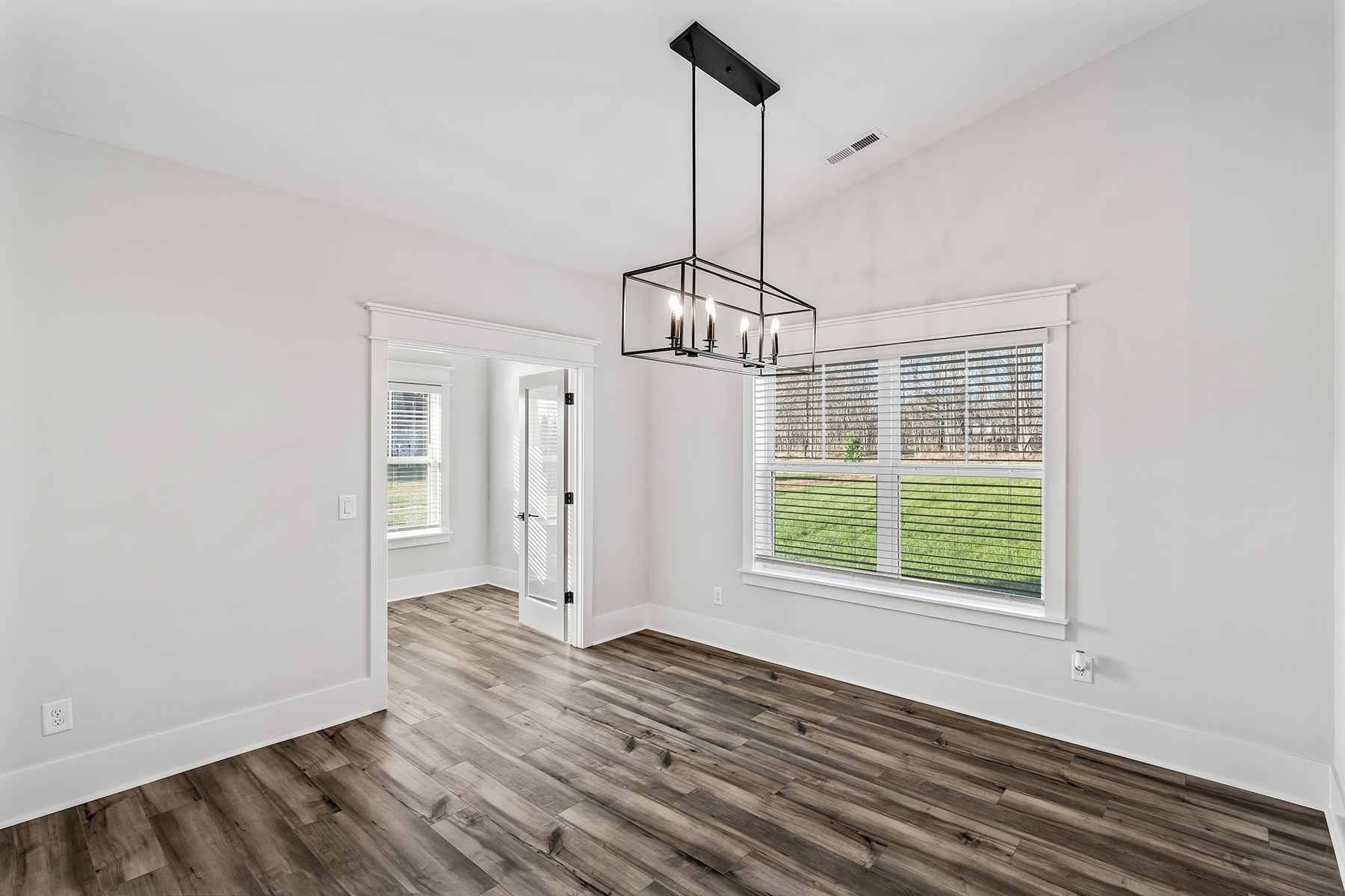 737 Brownlow Road White House, TN 37188 - Photo 7 of 16 a view of an empty room with wooden floor fridge and a window