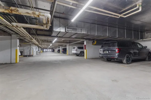 a view of parking garage with cars