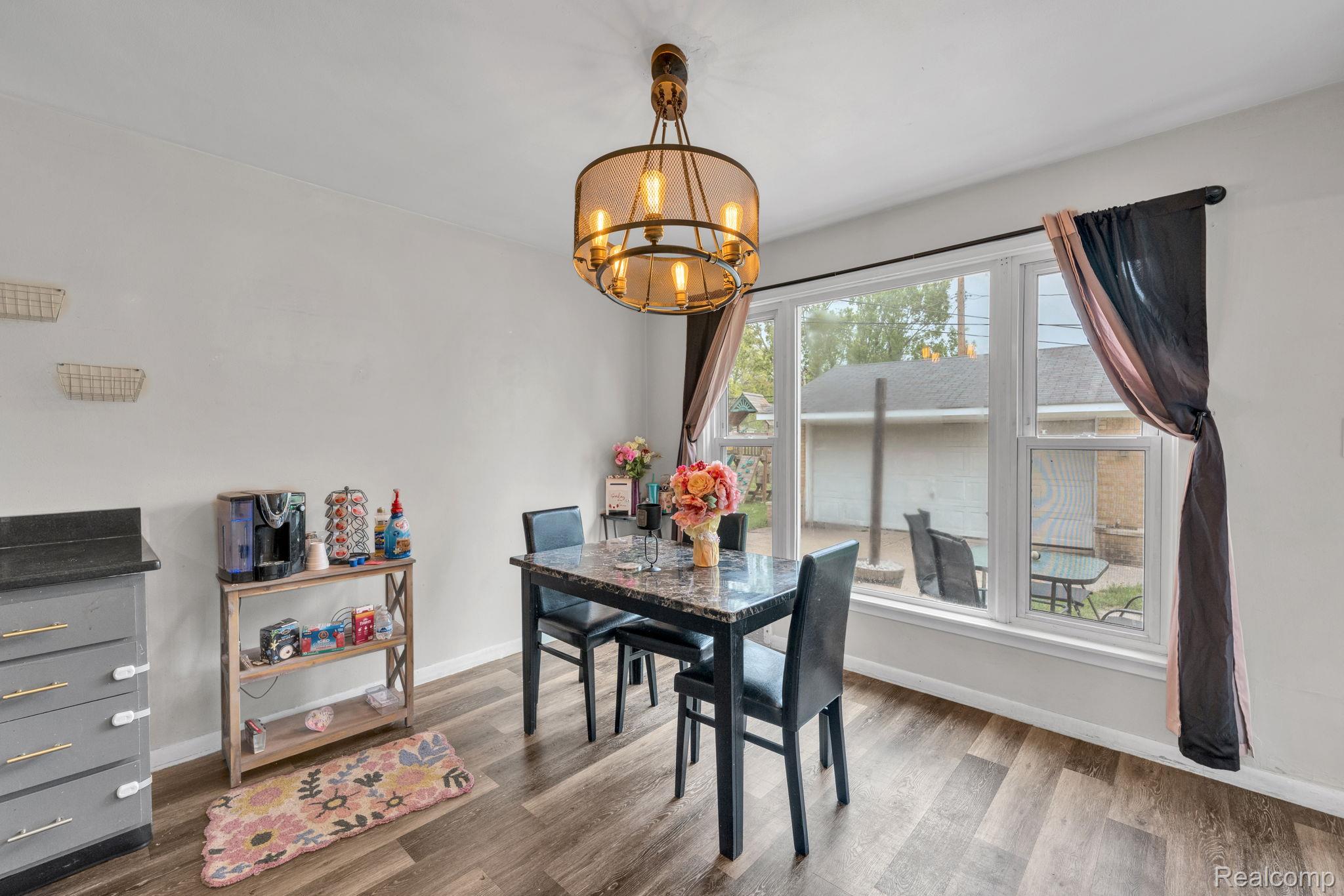 37022 Pinewood Road Wayne, MI 48184 - Photo 14 of 30 Dining room with suspended lighting and wood finished floors