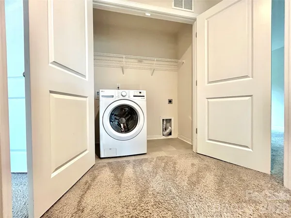 a view of a storage & utility room with a washer dryer