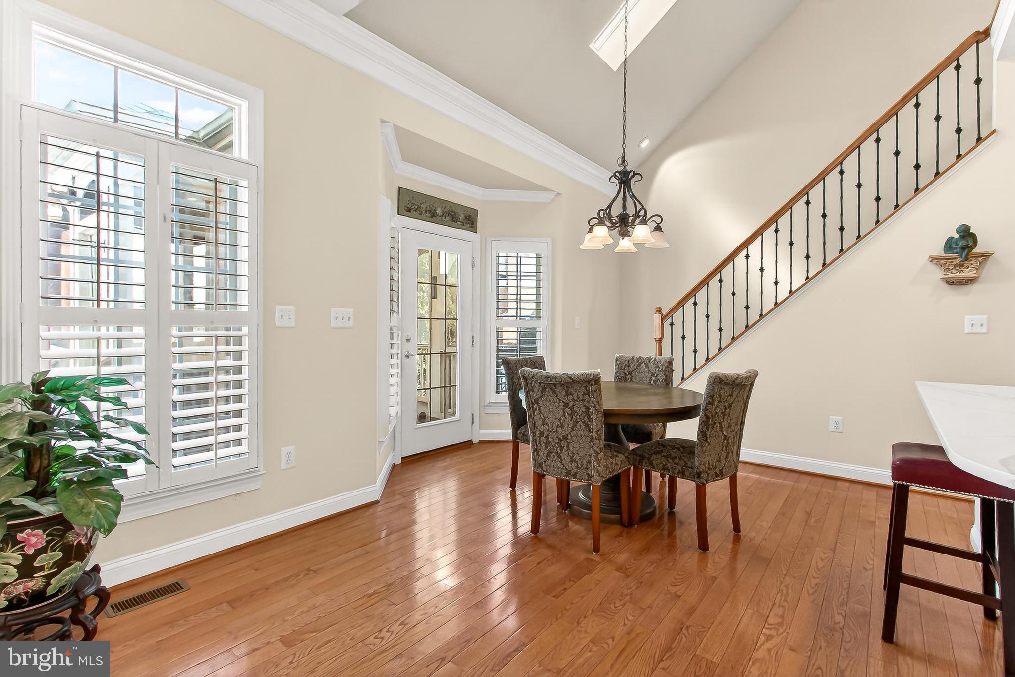 8471 Link Hills Loop Gainesville, VA 20155 - Photo 15 of 65 a view of a dining room with furniture window and wooden floor