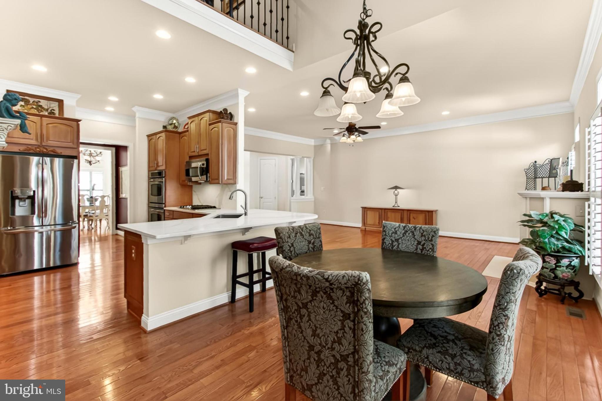 8471 Link Hills Loop Gainesville, VA 20155 - Photo 16 of 65 a view of a dining room with furniture and wooden floor