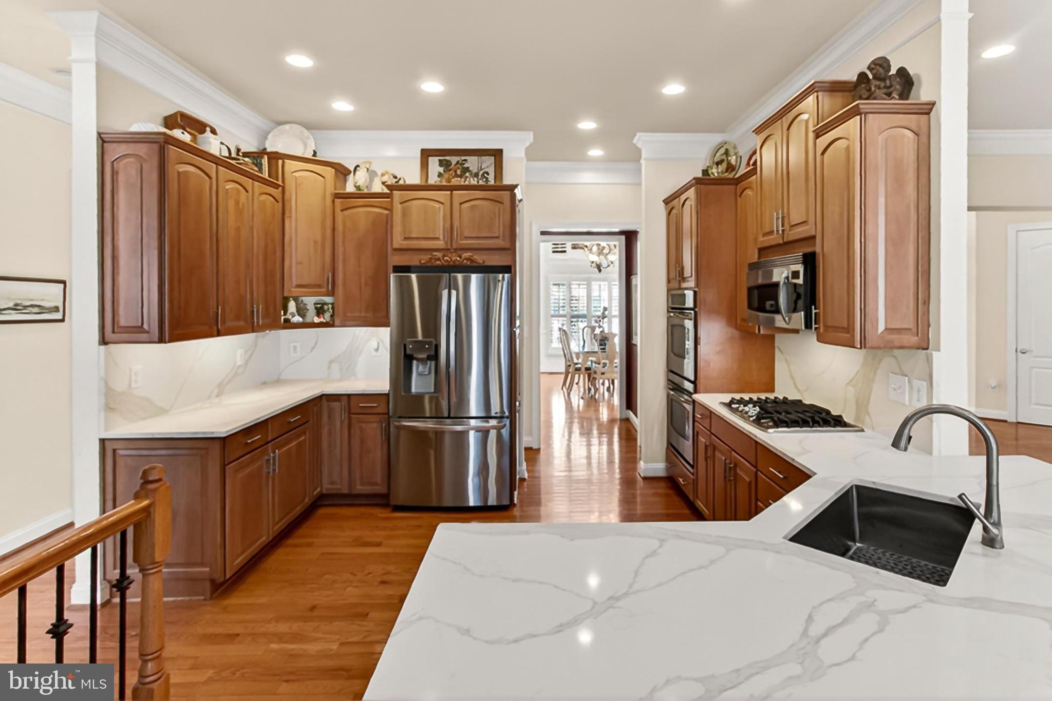 8471 Link Hills Loop Gainesville, VA 20155 - Photo 19 of 65 a kitchen with granite countertop a refrigerator and a sink