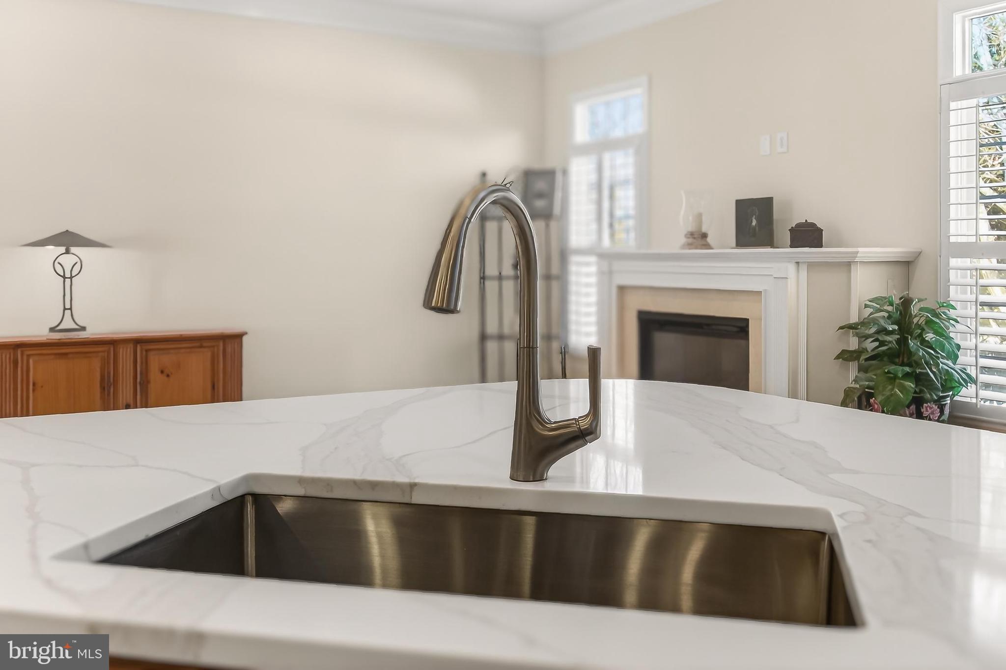 8471 Link Hills Loop Gainesville, VA 20155 - Photo 22 of 65 a kitchen with a sink cabinets and a fireplace