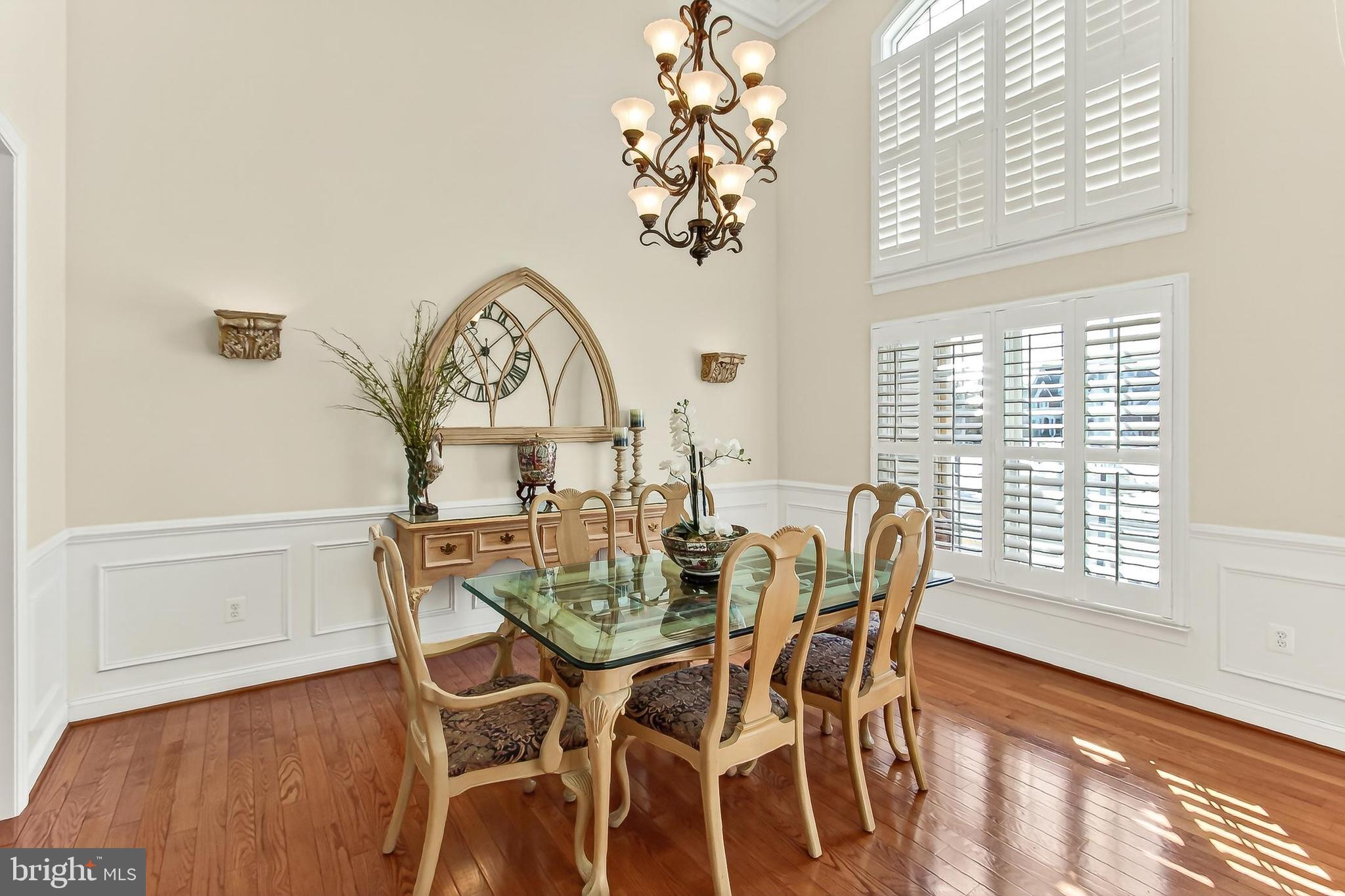 8471 Link Hills Loop Gainesville, VA 20155 - Photo 26 of 65 a view of a dining room with furniture window and wooden floor