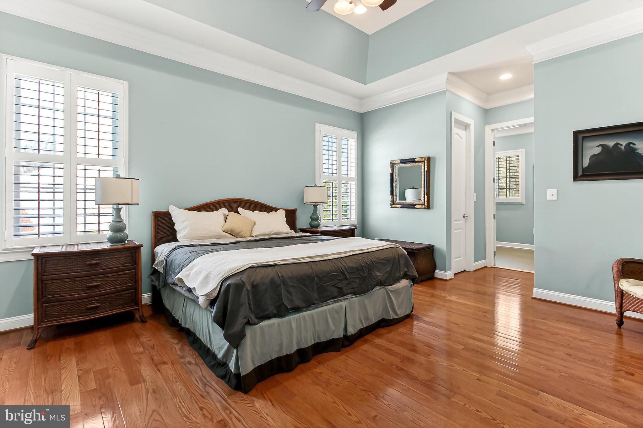8471 Link Hills Loop Gainesville, VA 20155 - Photo 29 of 65 a bedroom with a bed and wooden floor