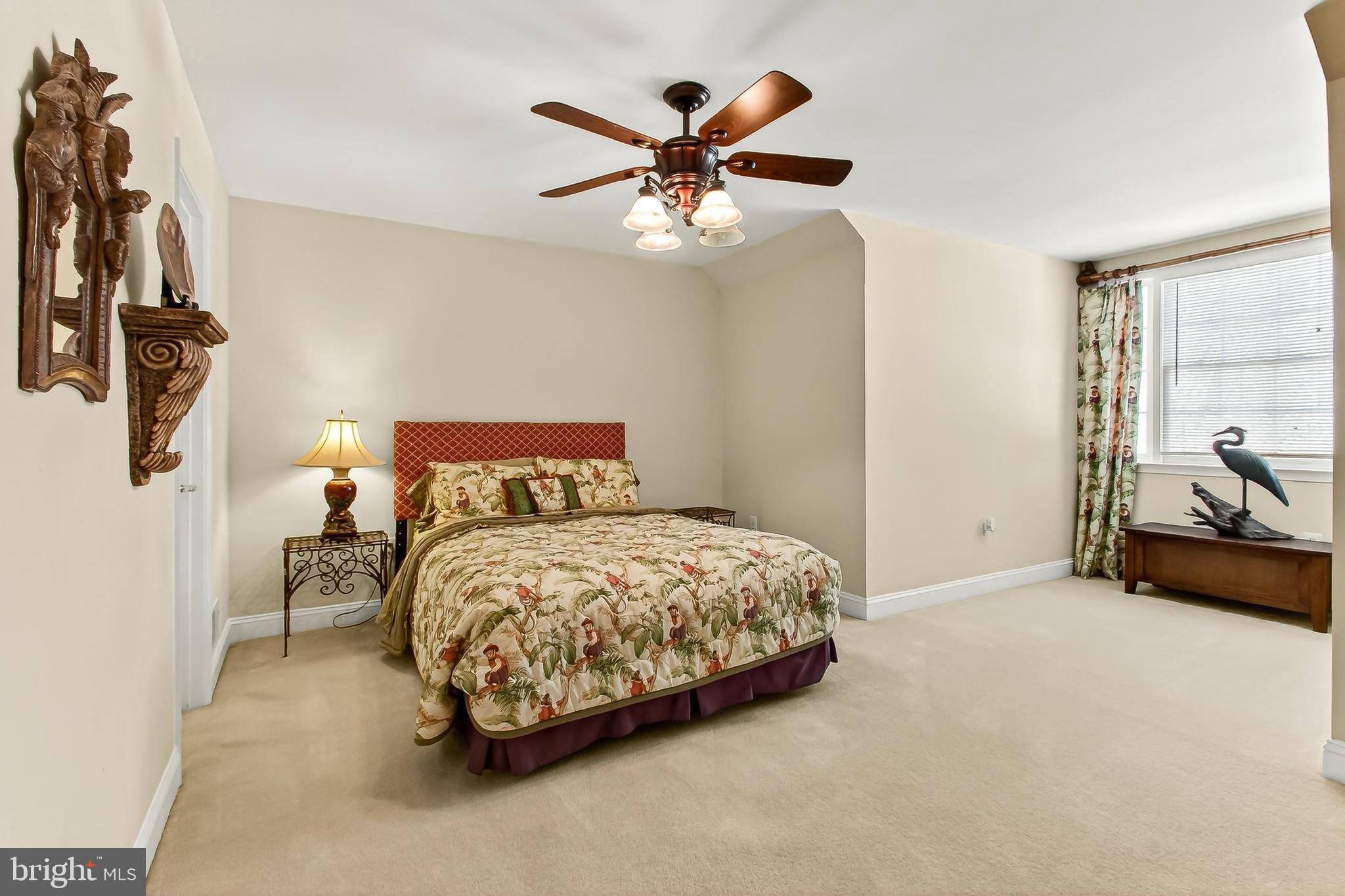 8471 Link Hills Loop Gainesville, VA 20155 - Photo 44 of 65 a bedroom with a bed and a ceiling fan