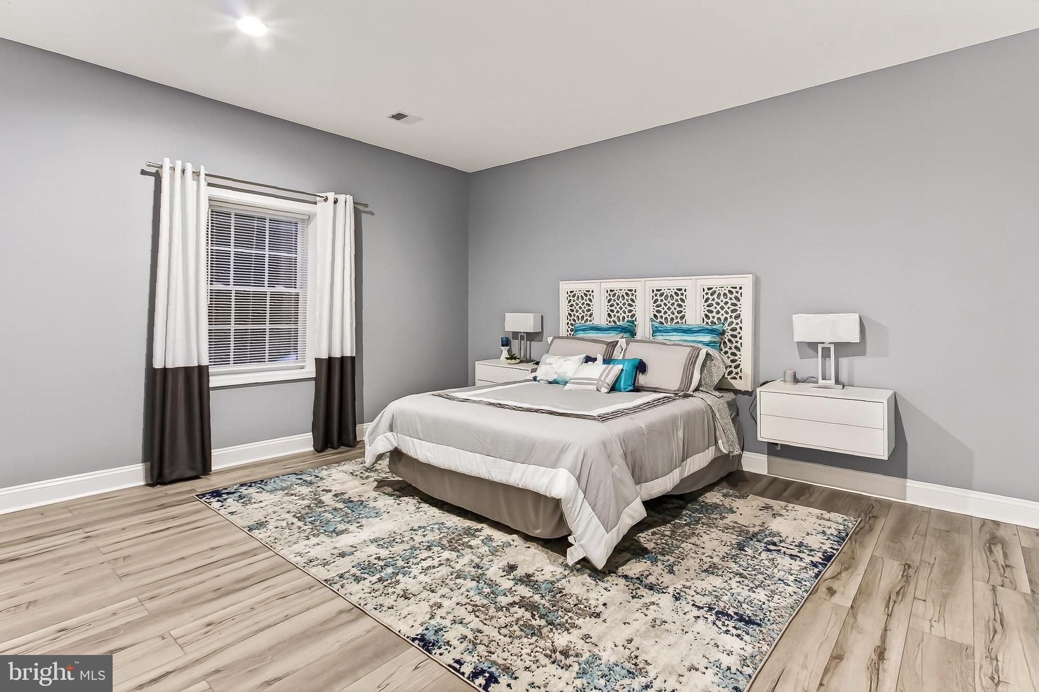 8471 Link Hills Loop Gainesville, VA 20155 - Photo 52 of 65 a bedroom with a bed and wooden floor