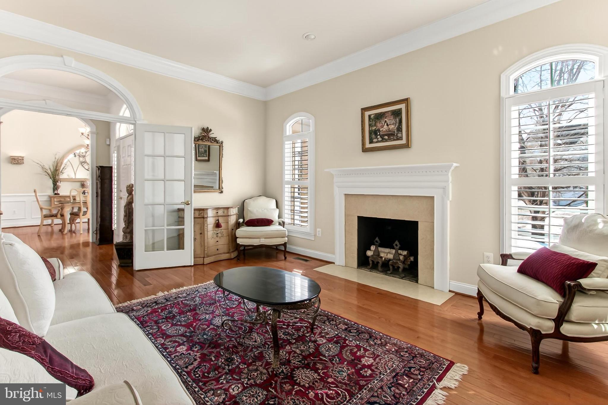 8471 Link Hills Loop Gainesville, VA 20155 - Photo 9 of 65 a living room with furniture a rug and a fireplace