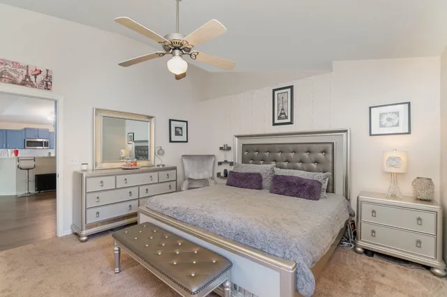 a bedroom with a bed and a chandelier