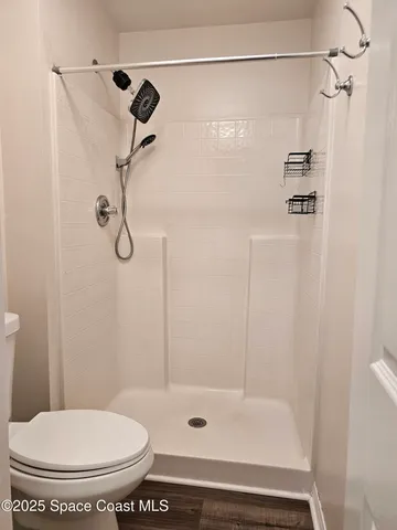 a bathroom with a shower and a toilet