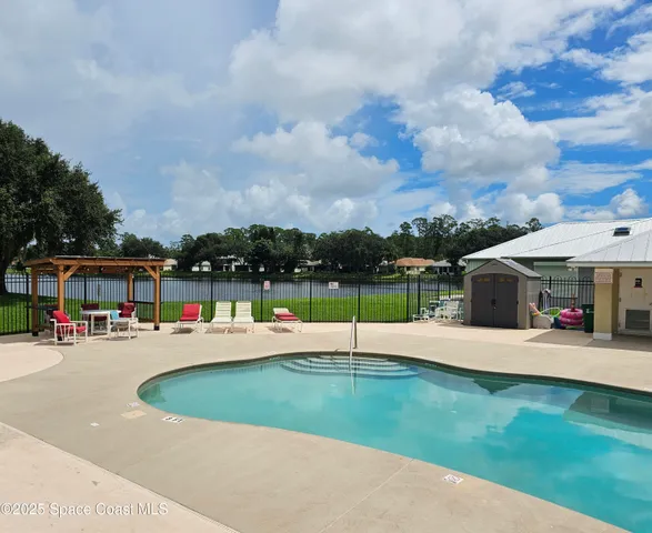 a green field with lots of trees in the background