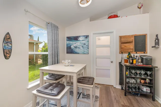 a view of a dining room with furniture wooden floor and a window