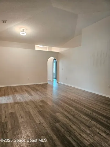 a view of a room with wooden floor and window
