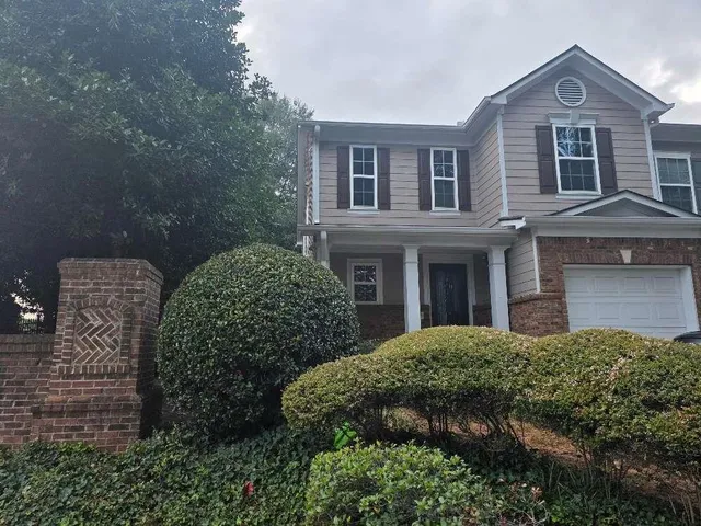 a view of a brick house with many windows