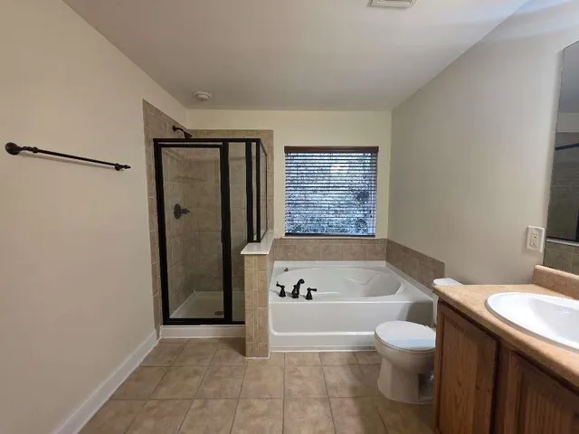 a white bath tub sitting next to a white toilet