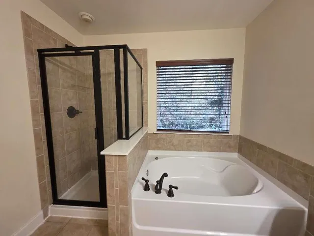 a bathroom with a bathtub and a shower