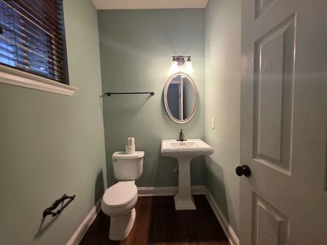 a bathroom with a sink toilet and a mirror