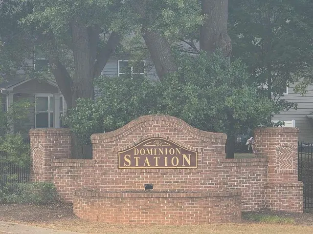 a view of a brick building next to a yard