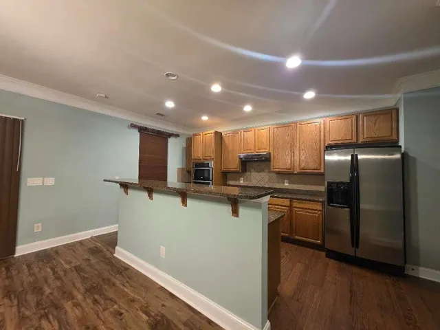 a kitchen with stainless steel appliances a refrigerator sink and microwave