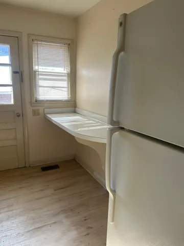 an empty room with wooden floor and closet area