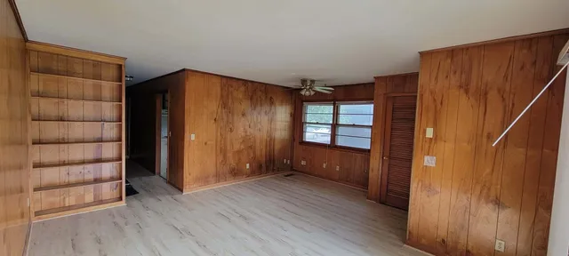 a view of a room with wooden floor and doors