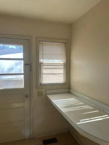 a view of wooden floor and closet area