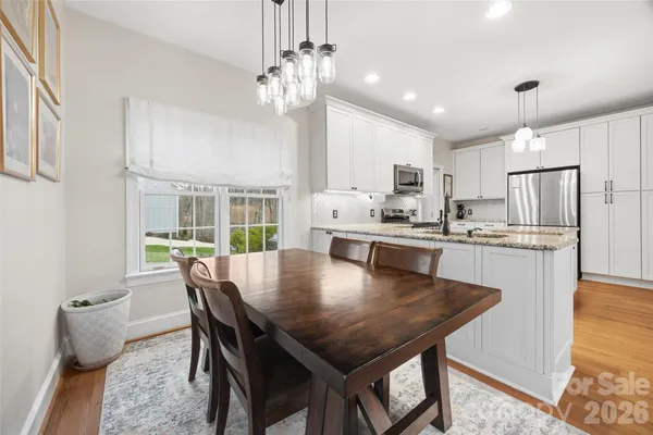 a view of a dining room with furniture and a chandelier