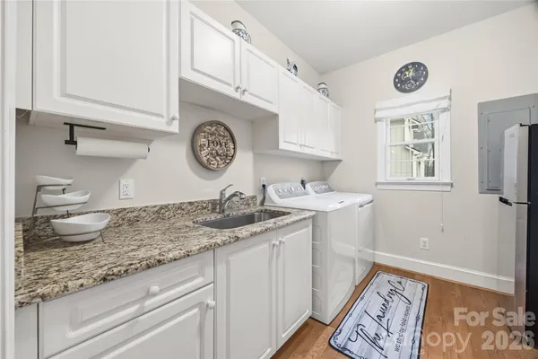 a kitchen with a sink a stove and cabinets