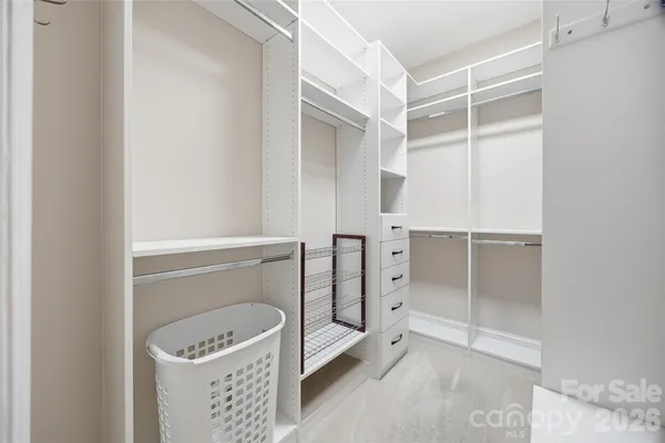 a room with a wooden floor and white walls