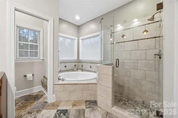 a bathroom with a double vanity sink a mirror and a shower