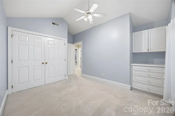 a view of an empty room with closet