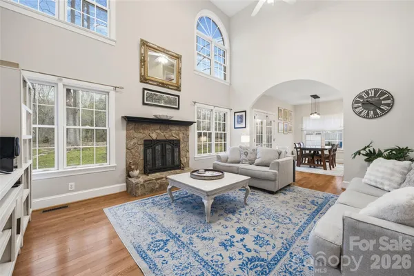 a living room with furniture a rug and a fireplace