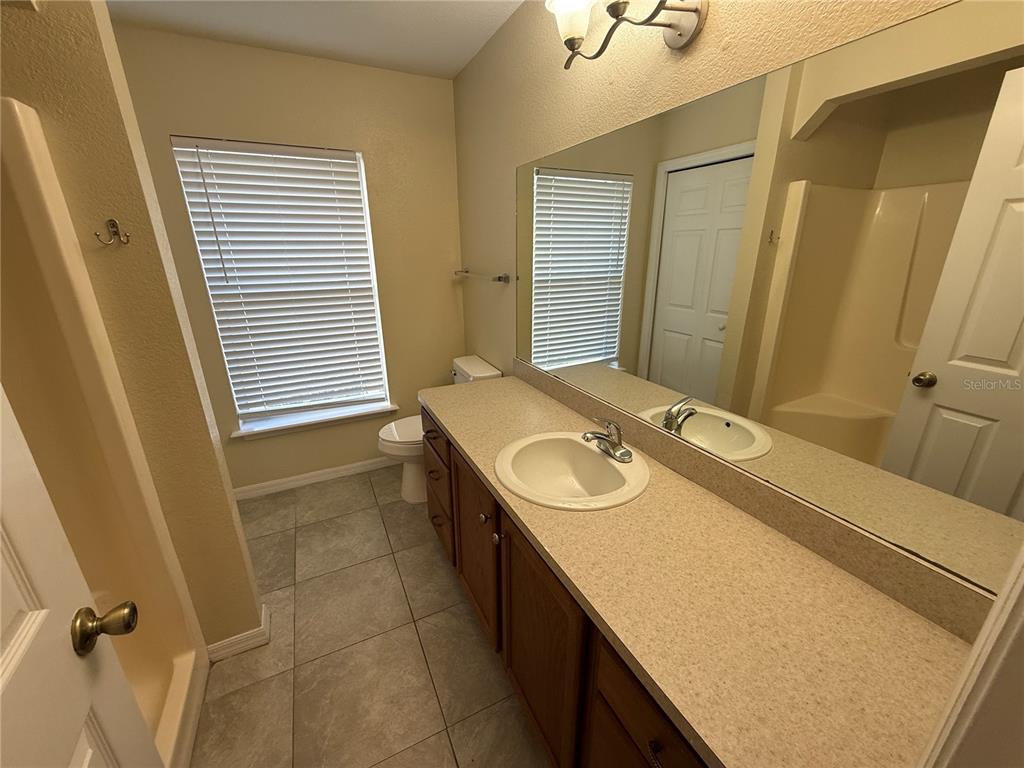 61 Laurel Drive Ocala, FL 34480 - Photo 12 of 14 a bathroom with a sink and a washing machine
