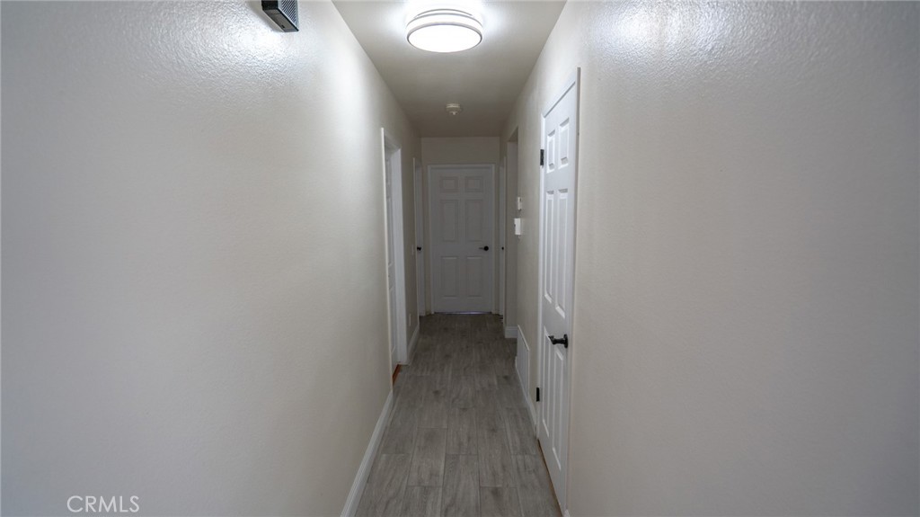 1185 Mountain Gate Road Upland, CA 91786 - Photo 15 of 39 hallway leading to bedrooms and garage.