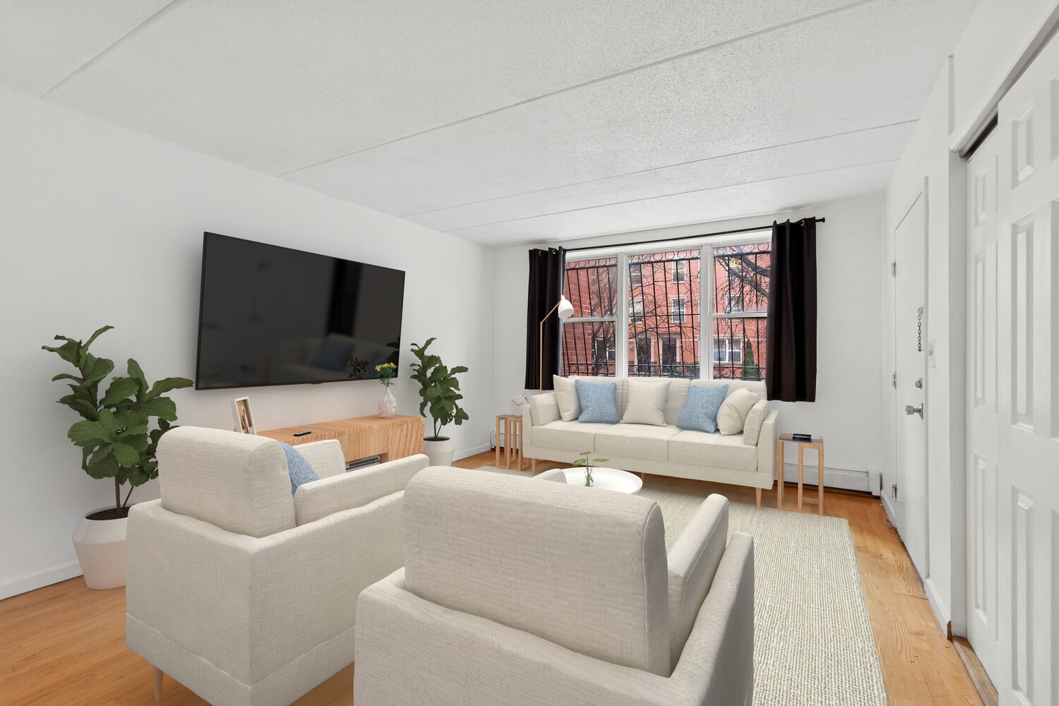 323 East 119th Street, Unit 2 Manhattan, NY 10035 - Photo 3 of 12 a living room with furniture and a flat screen tv
