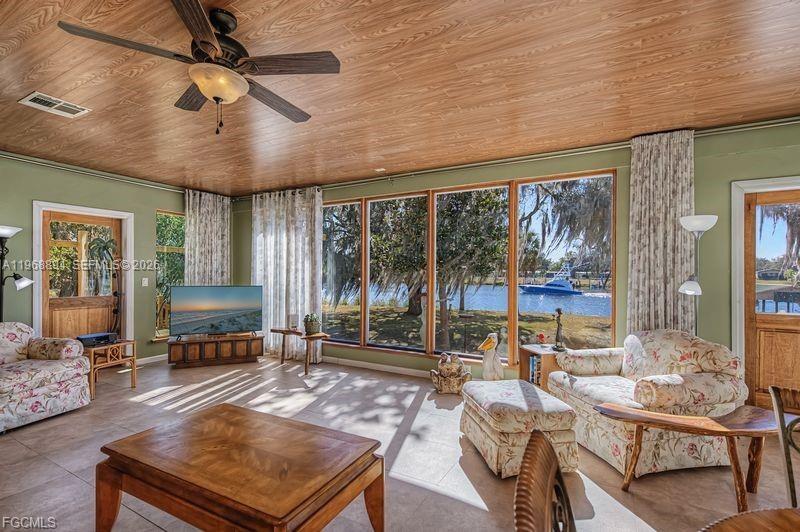1209 County Road LaBelle, FL 33935 - Photo 17 of 40 a living room with furniture a flat screen tv and a large window
