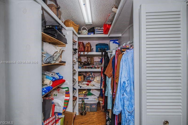 1209 County Road LaBelle, FL 33935 - Photo 25 of 40 a view of walk in closet with clothes