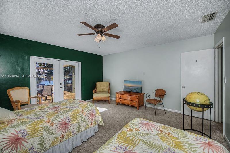 1209 County Road LaBelle, FL 33935 - Photo 28 of 40 a bedroom with a bed a couch and a chandelier
