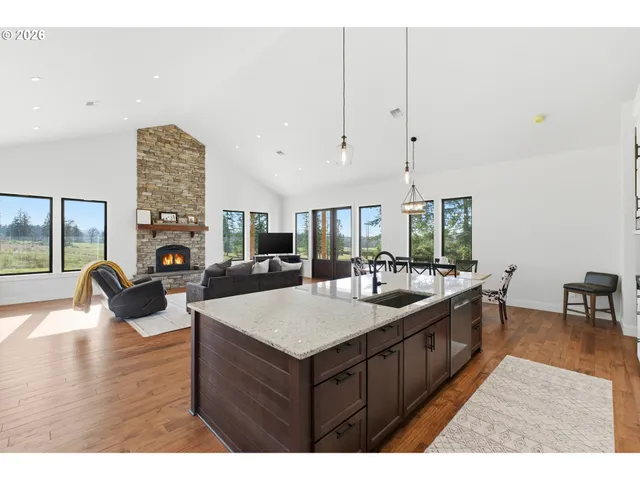 a large kitchen with a stove and a large window